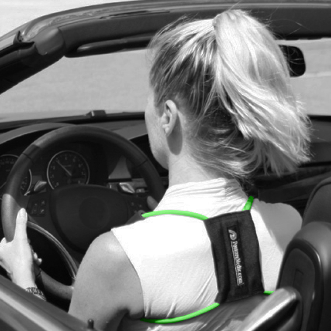 Woman wearing a Posture Medic posture corrector while driving. 